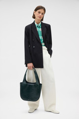 Profile view of model wearing the Oroton Emilia Crackle Tote in Shade Green and Premium crackle leather for Women .
