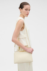Profile view of model wearing the Oroton Miriam Smooth Day Bag in Vanilla Bean and Smooth cow leather for Women .