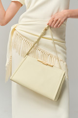 Profile view of model wearing the Oroton Miriam Smooth Day Bag in Vanilla Bean and Smooth cow leather for Women .