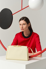 Profile view of model wearing the Oroton Miriam Smooth Day Bag in Vanilla Bean and Smooth cow leather for Women .