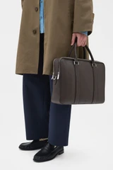 Profile view of model wearing the Oroton Nicholas Smooth Double Zip Briefcase in Dark Chocolate and Soft nappa cow leather for Men .