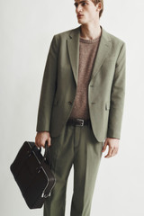 Profile view of model wearing the Oroton Nicholas Smooth Double Zip Briefcase in Black and Soft nappa cow leather for Men .