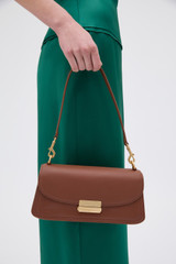 Profile view of model wearing the Oroton Ava Smooth Shoulder Bag in Chestnut and Smooth cow leather for Women .