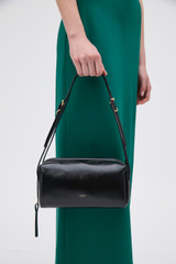 Profile view of model wearing the Oroton Charlie Crackle Shoulder Bag in Black and Premium crackle leather for Women .
