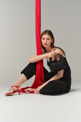 Profile view of model wearing the Oroton Clara Satin Mini Bag in Black and Satin fabric material for Women .