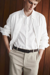 Profile view of model wearing the Oroton Otto Smooth 35MM Belt in Dark Chocolate and Premium smooth cow leather for Men .