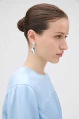 Profile view of model wearing the Oroton Banks Drop Earrings in Bright Silver and Premium brass material for Women .