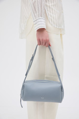 Profile view of model wearing the Oroton Charlie Smooth Shoulder Bag in Dusk Blue and Smooth sheep leather for Women .