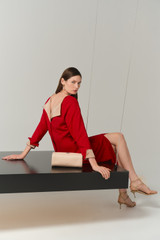 Profile view of model wearing the Oroton Two Tone Crepe Dress in Rich Red and 96% viscose and 4% spandex blend fabric for Women .