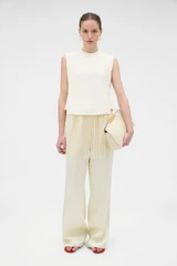 Profile view of model wearing the Oroton Fringe Detail Top in Soft Cream and 96% viscose and 4% spandex blend fabric for Women .