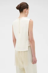 Profile view of model wearing the Oroton Fringe Detail Top in Soft Cream and 96% viscose and 4% spandex blend fabric for Women .