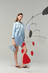Profile view of model wearing the Oroton Double Satin Mini Dress in Cloud Blue and 100% viscose fabric for Women .