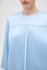 Profile view of model wearing the Oroton Double Satin Mini Dress in Cloud Blue and 100% viscose fabric for Women .