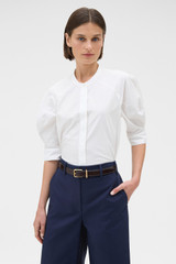 Profile view of model wearing the Oroton Sleeve Detail Shirt in Antique White and 100% cotton poplin fabric for Women .