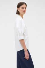 Profile view of model wearing the Oroton Sleeve Detail Shirt in Antique White and 100% cotton poplin fabric for Women .