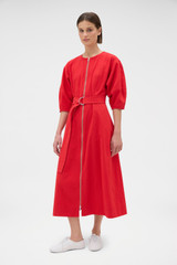 Profile view of model wearing the Oroton Zip Through Dress in Market Red and 100% cotton fabric for Women .