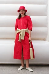 Profile view of model wearing the Oroton Zip Through Dress in Market Red and 100% cotton fabric for Women .