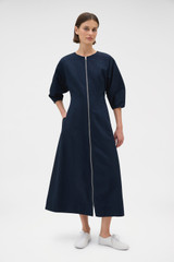 Profile view of model wearing the Oroton Zip Through Dress in North Sea and 77% cotton and 23% linen blend fabric for Women .