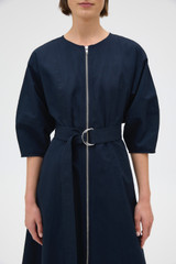 Profile view of model wearing the Oroton Zip Through Dress in North Sea and 77% cotton and 23% linen blend fabric for Women .