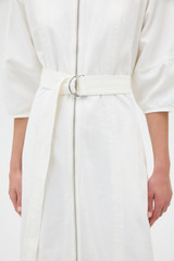 Profile view of model wearing the Oroton Zip Through Dress in Antique White and 100% cotton fabric for Women .