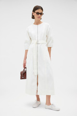 Profile view of model wearing the Oroton Zip Through Dress in Antique White and 100% cotton fabric for Women .