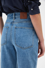Profile view of model wearing the Oroton Straight Leg Denim Jean in Mid Vintage Wash and 100% cotton fabric for Women .