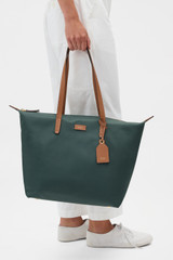 Profile view of model wearing the Oroton Lilly Nylon Light Weight Tote Bag in Evergreen/Cognac and Nylon material for Women .