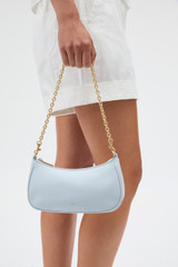 Profile view of model wearing the Oroton Eve Crackle Mini Baguette in Mist and Premium crackle leather for Women .