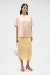Profile view of model wearing the Oroton Double Satin Tee in Peach and 100% viscose fabric for Women .