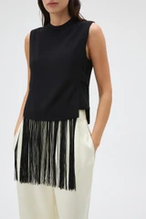 Profile view of model wearing the Oroton Fringe Detail Top in Black and 96% viscose and 4% spandex blend fabric for Women .