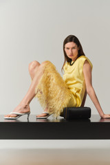 Profile view of model wearing the Oroton Feather Jacquard Sheath Dress in Butter and 100% polyester fabric for Women .