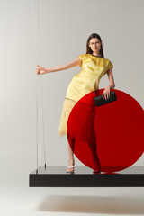 Profile view of model wearing the Oroton Feather Jacquard Sheath Dress in Butter and 100% polyester fabric for Women .