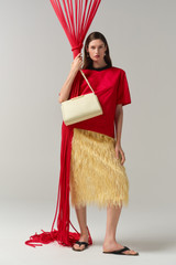 Profile view of model wearing the Oroton Feather Jacquard Skirt in Butter and 100% polyester fabric for Women .