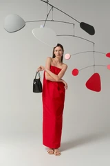 Profile view of model wearing the Oroton Tuck Detail Gown in Poppy and 85% polyester and 15% silk Mikado fabric for Women .