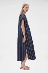 Profile view of model wearing the Oroton Stripe Detail Dress in Denim Blue and 100% cotton fabric for Women .