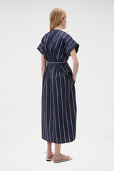 Profile view of model wearing the Oroton Stripe Detail Dress in Denim Blue and 100% cotton fabric for Women .