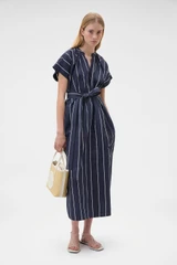 Profile view of model wearing the Oroton Stripe Detail Dress in Denim Blue and 100% cotton fabric for Women .