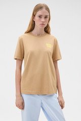 Profile view of model wearing the Oroton Maggie Graphic Tee in Praline and 100% cotton single jersey fabric for Women .