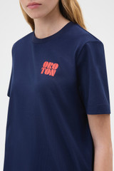 Profile view of model wearing the Oroton Maggie Graphic Tee in North Sea and 100% cotton single jersey fabric for Women .