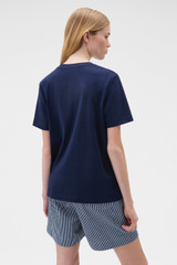 Profile view of model wearing the Oroton Maggie Graphic Tee in North Sea and 100% cotton single jersey fabric for Women .