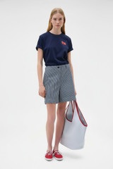 Profile view of model wearing the Oroton Maggie Graphic Tee in North Sea and 100% cotton single jersey fabric for Women .