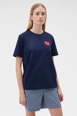 Profile view of model wearing the Oroton Maggie Graphic Tee in North Sea and 100% cotton single jersey fabric for Women .