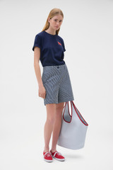 Profile view of model wearing the Oroton Maggie Graphic Tee in North Sea and 100% cotton single jersey fabric for Women .