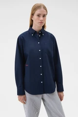Profile view of model wearing the Oroton Oxford Shirt in North Sea and 100% cotton fabric for Women .