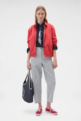 Profile view of model wearing the Oroton Oxford Shirt in North Sea and 100% cotton fabric for Women .