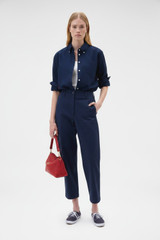 Profile view of model wearing the Oroton Oxford Shirt in North Sea and 100% cotton fabric for Women .
