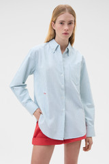 Profile view of model wearing the Oroton Oxford Stripe Shirt in Ivy Green and 100% cotton fabric for Women .
