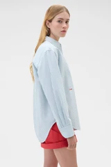 Profile view of model wearing the Oroton Oxford Stripe Shirt in Ivy Green and 100% cotton fabric for Women .