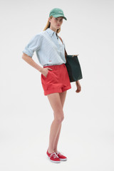 Profile view of model wearing the Oroton Oxford Stripe Shirt in Ivy Green and 100% cotton fabric for Women .