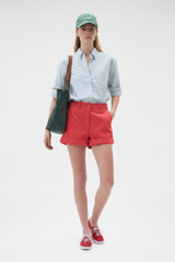 Profile view of model wearing the Oroton Oxford Stripe Shirt in Ivy Green and 100% cotton fabric for Women .